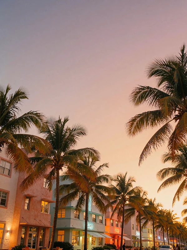 Miami beachfront avenue at dusk with palm-lined pastel facades under a violet sky